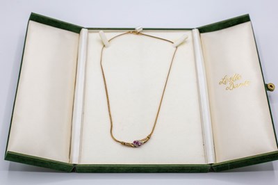 Lot 216 - A diamond and ruby pendant necklace, set in...