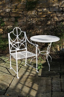 Lot 631 - An iron garden armchair and table, 78cm diameter