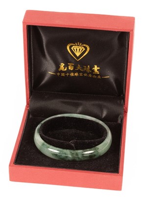 Lot 64 - A Chinese jade bangle, with certificate, boxed,...