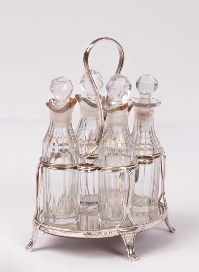 Lot 27 - A George III silver and cut glass cruet stand,...