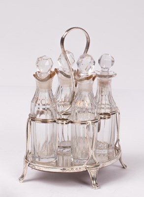 Lot 27 - A George III silver and cut glass cruet stand,...