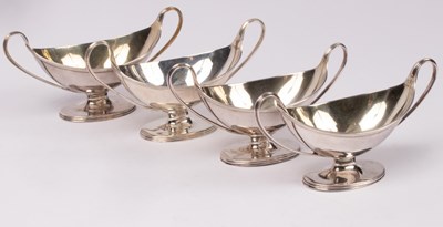 Lot 36 - A set of four George III silver and silver...