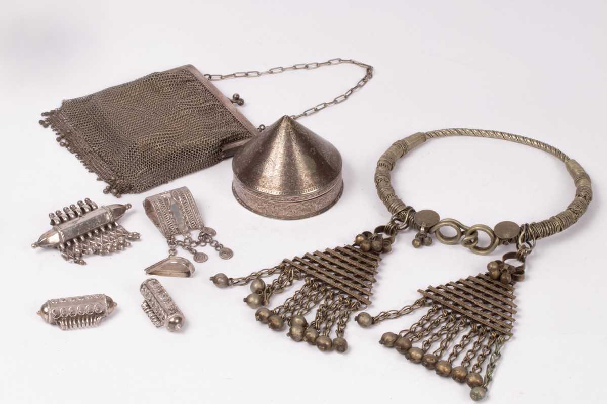 Lot 94 - An Indian white metal tribal hasli, an Indian...