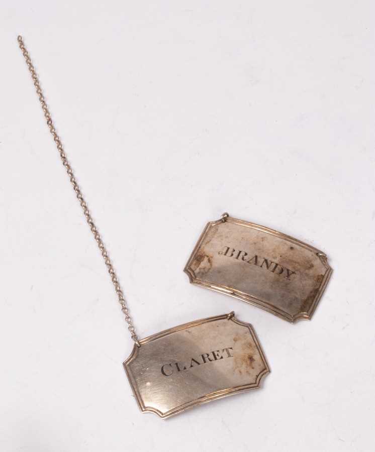 Lot 100 - A pair of Anglo Indian silver decanter labels,...