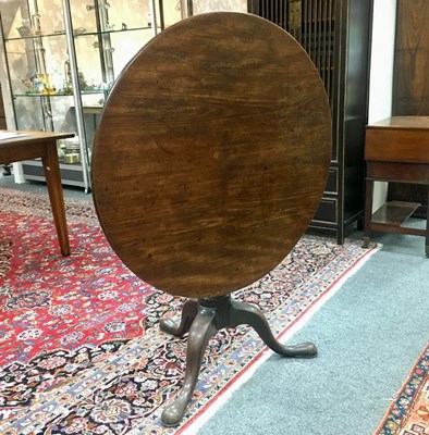 Lot 709 - An 18th Century walnut circular tilt-top table,...