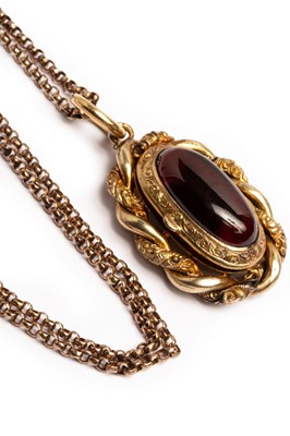Lot 50 - A Victorian gilt metal and garnet set oval...