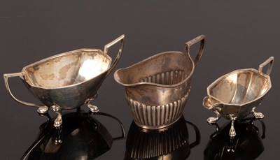 Lot 53 - A half-ribbed silver cream jug, Chester 1899,...