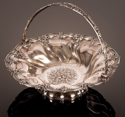 Lot 67 - A George IV silver swing handled basket,...