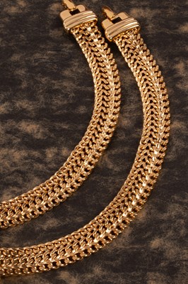 Lot 60 - A pair of Monet yellow metal bracelets