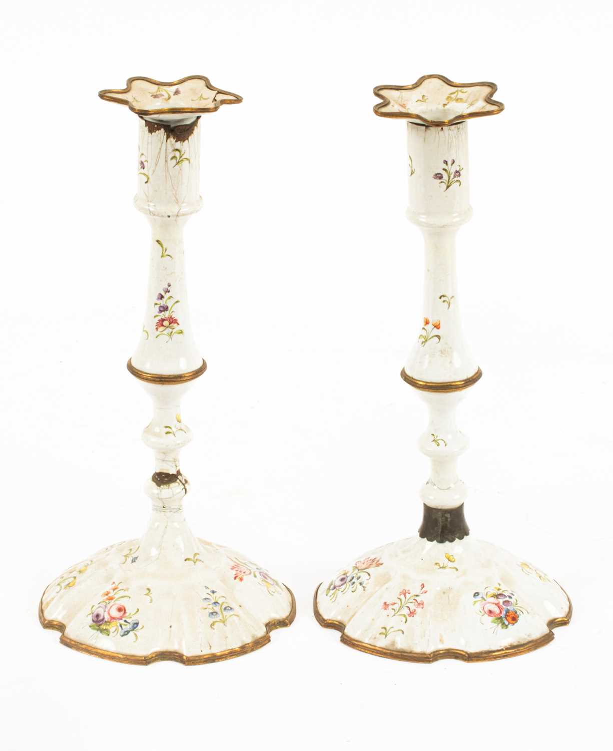Lot 91 - A pair of South Staffordshire white enamel candlesticks