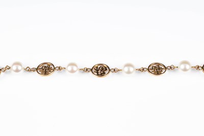 Lot 228 - A 14k gold and Mikimoto pearl bracelet