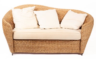 Lot 635 - A woven rush two-seat conservatory sofa