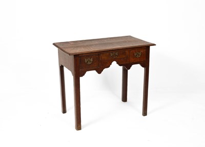 Lot 642 - A George III oak lowboy