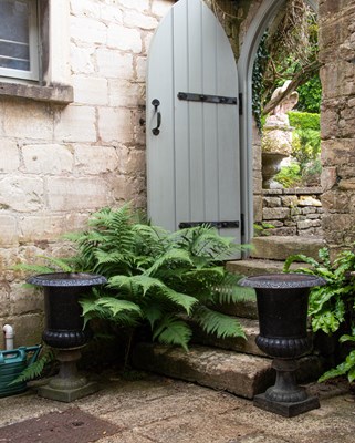 Lot 1 - A pair of cast iron urns