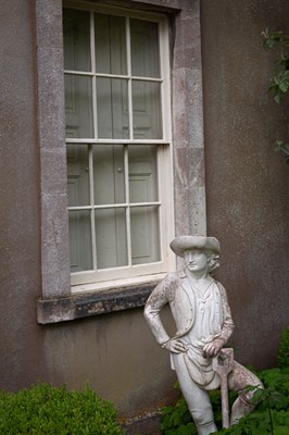 Lot 19 - A pair of reconstituted figures of gardeners after John Cheere