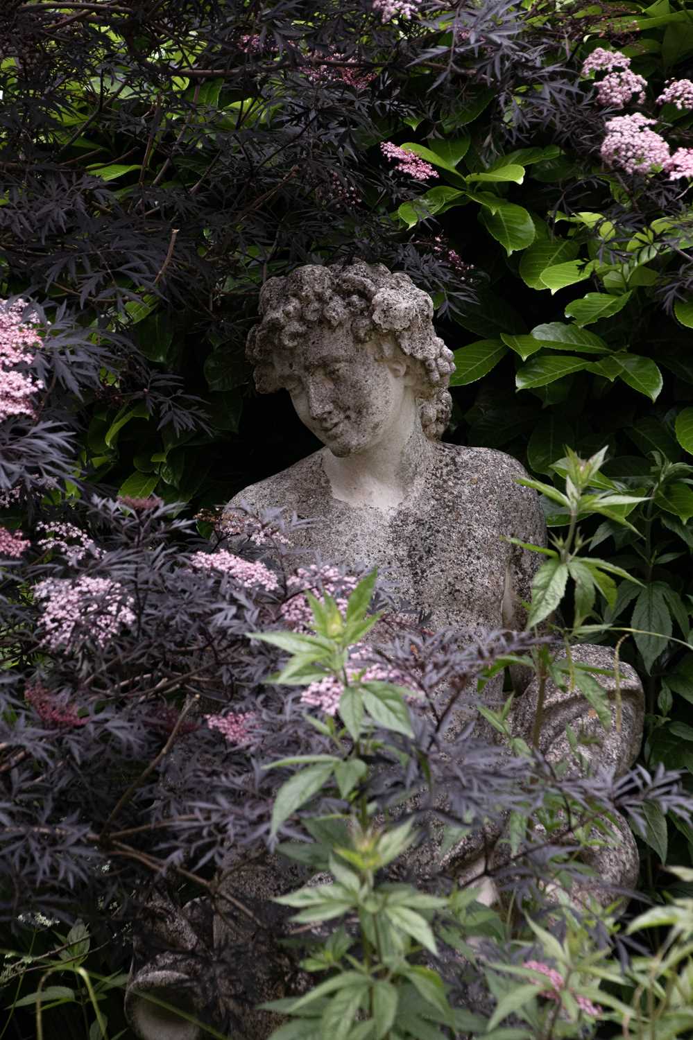 Lot 22 - A reconstituted stone figure of Bacchus