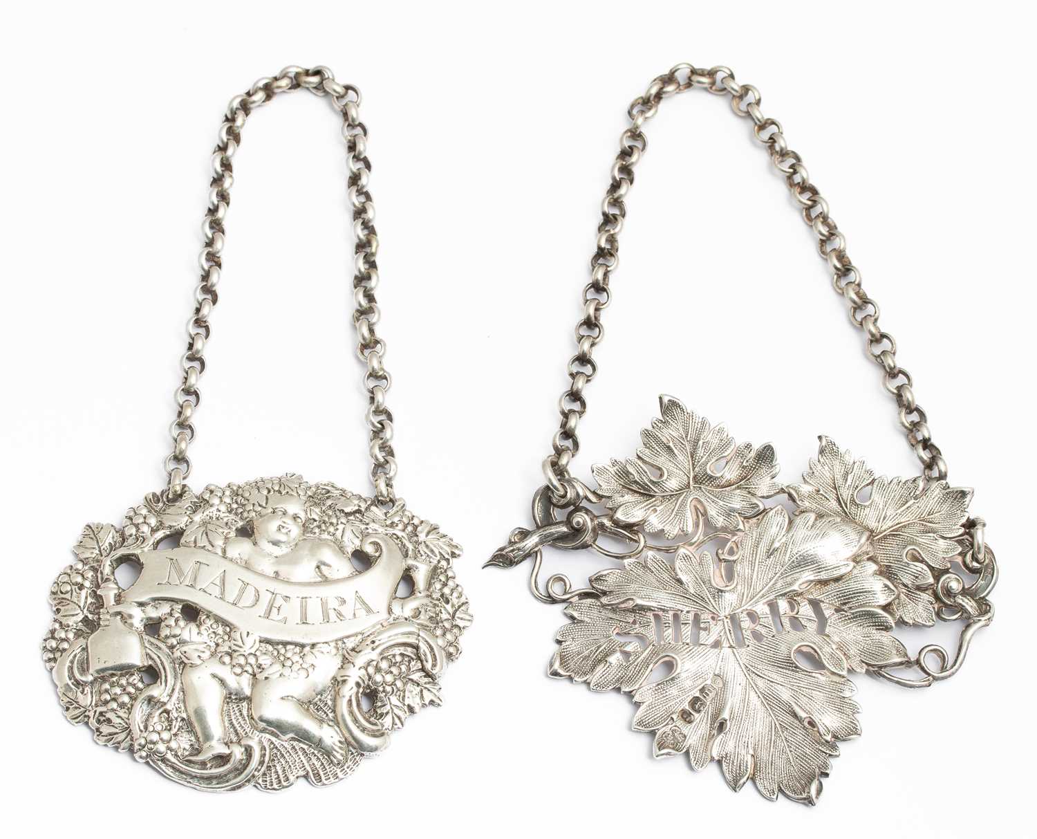 Lot 41 - Two late Georgian cast silver decanter labels