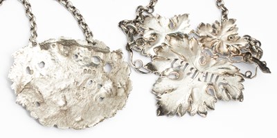 Lot 41 - Two late Georgian cast silver decanter labels