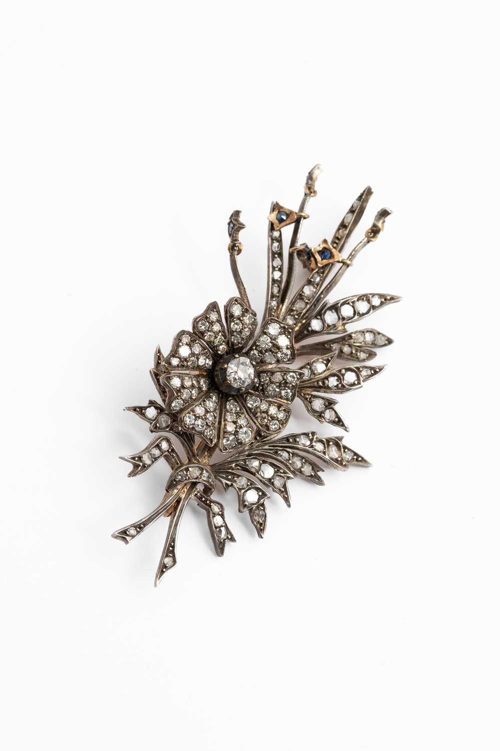 Lot 3 - A yellow metal and diamond floral spray brooch