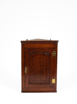 Lot 368 - A George III oak wall hanging corner cupboard