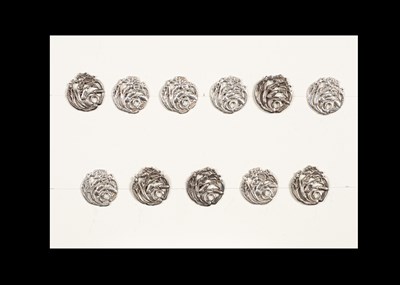 Lot 204 - A group of eleven Art Nouveau matched silver buttons of pierced floral design