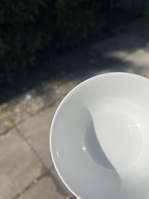 Lot 574 - A small pink monochrome bowl
