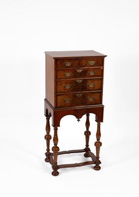Lot 283 - A George I style walnut and featherbanded chest on stand