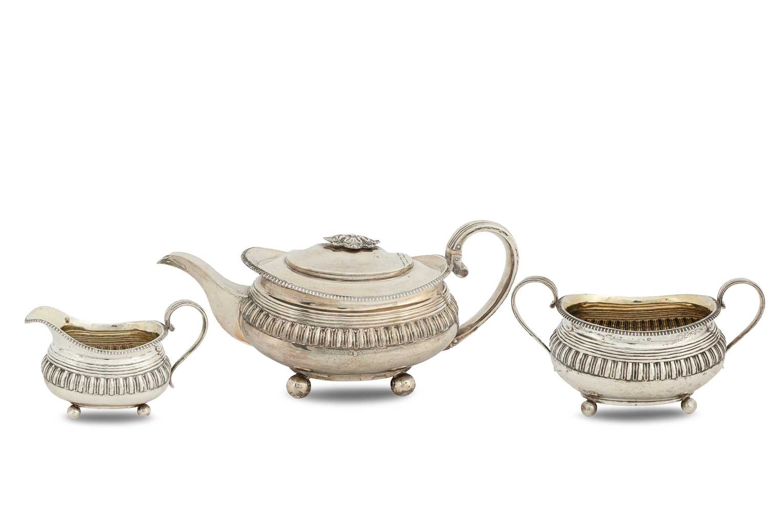 Lot 46 - A Georgian three-piece silver and silver-gilt tea set
