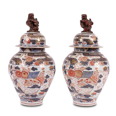 Lot 556 - A pair of Imari baluster vases and covers