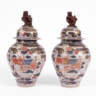 Lot 556 - A pair of Imari baluster vases and covers