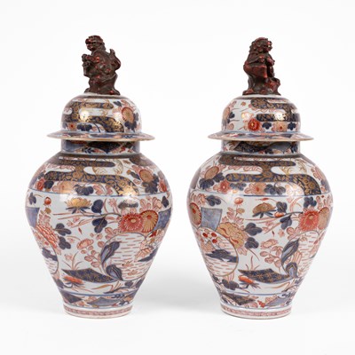 Lot 556 - A pair of Imari baluster vases and covers