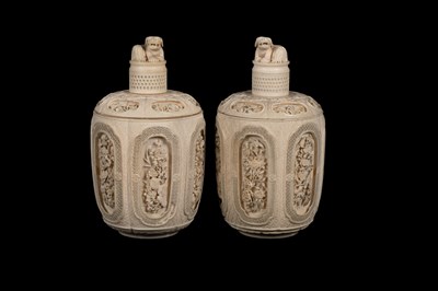 Lot 642 - A pair of Chinese carved ivory jars and covers