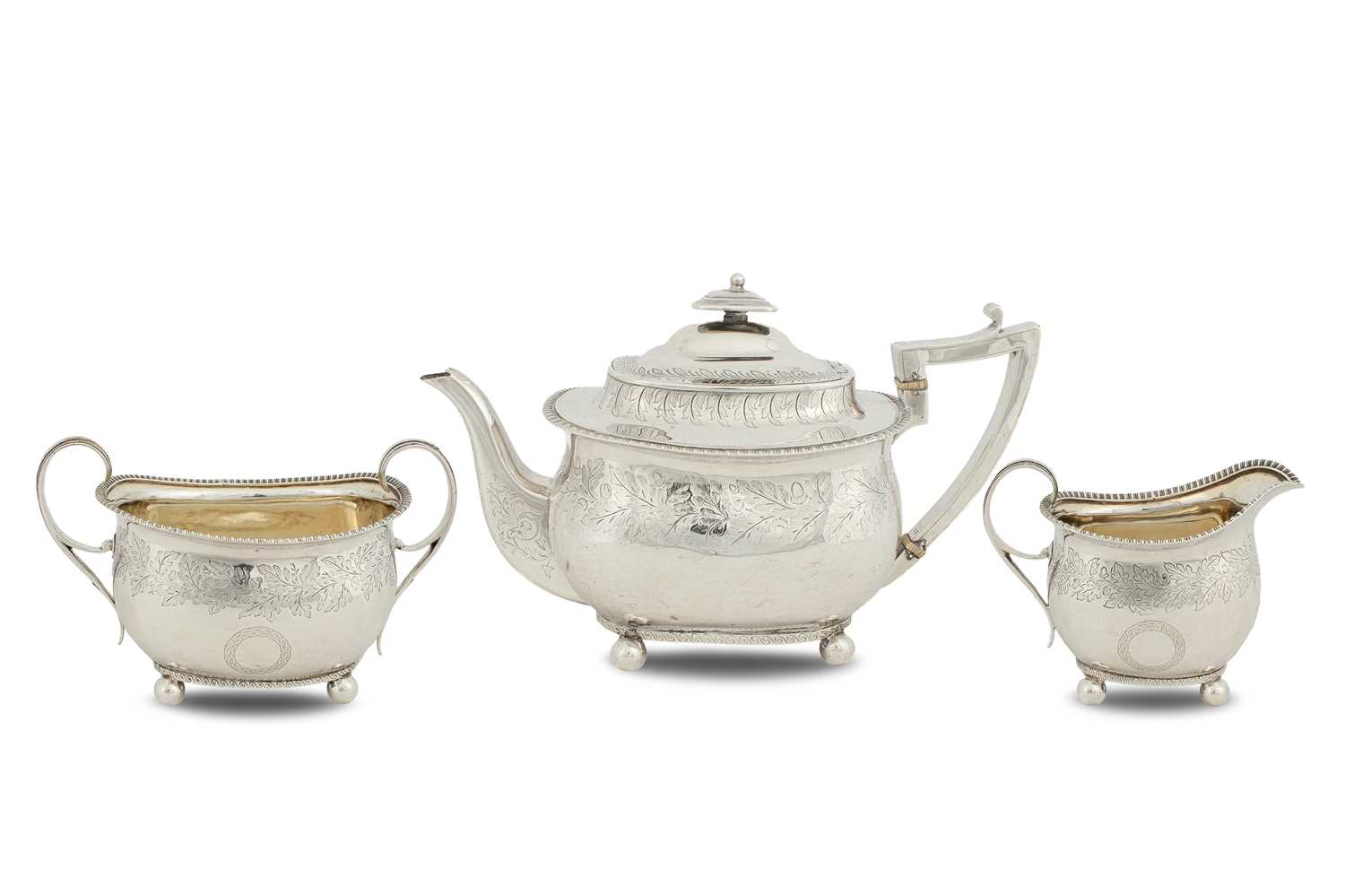 Lot 20 - A George III three-piece silver and silver-gilt tea set