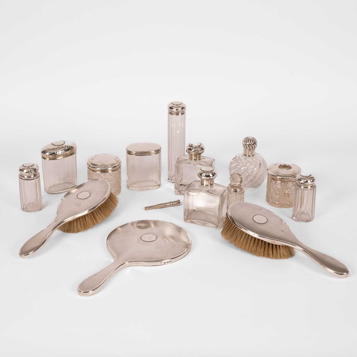 Lot 27 - A quantity of silver topped glass dressing table bottles