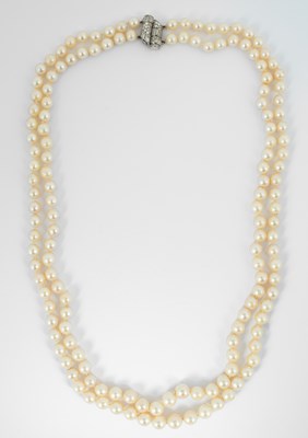 Lot 166 - A two-row cultured pearl necklace with a white metal and diamond clasp