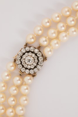Lot 167 - A three-row cultured pearl necklace with diamond cluster clasp