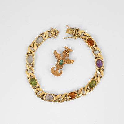 Lot 164 - A yellow metal and emerald brooch of Aztec design