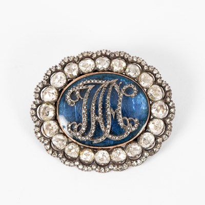 Lot 127 - An oval paste and blue enamel brooch