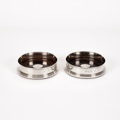 Lot 9 - A pair of silver mounted wine coasters