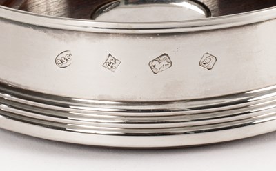 Lot 9 - A pair of silver mounted wine coasters