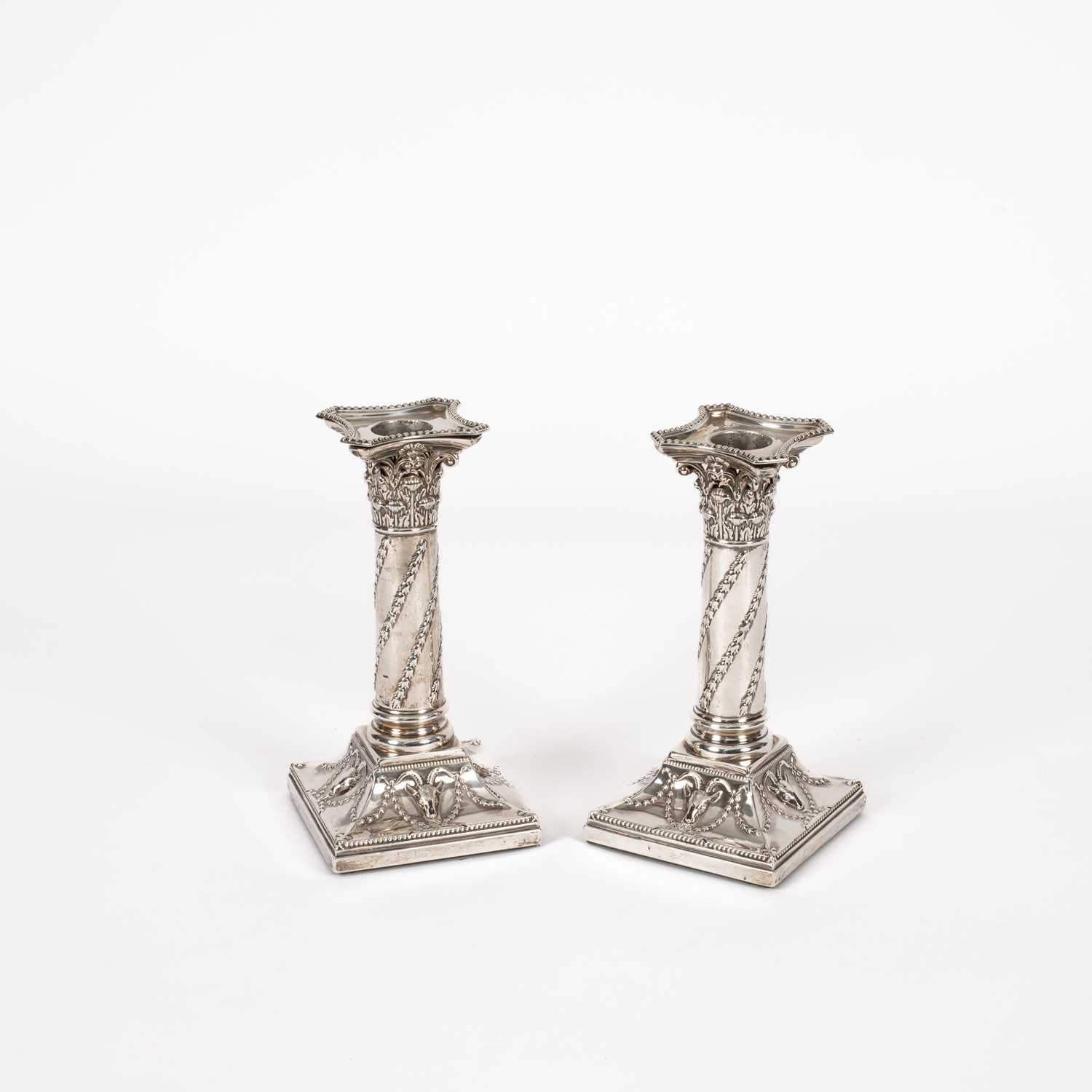 Lot 10 - A pair of Victorian silver mounted candlesticks