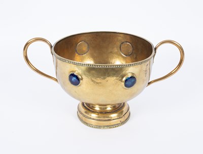 Lot 510 - An Arts & Crafts brass twin-handled pedestal bowl