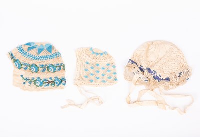 Lot 833 - Three European beaded baby's caps