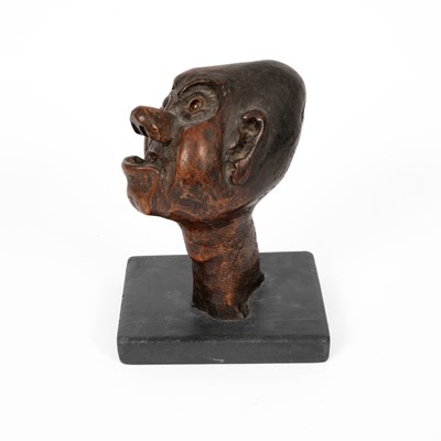 Lot 519 - A wooden carved head of a bald man