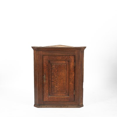 Lot 10 - A George III oak corner cupboard