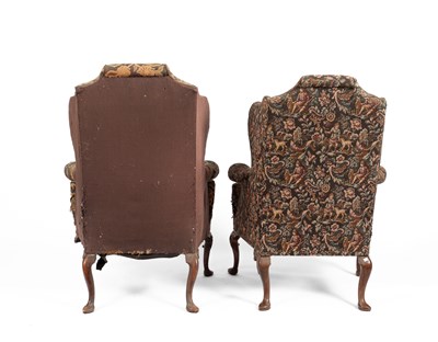 Lot 801 - A pair of upholstered wingback armchairs of Queen Anne design