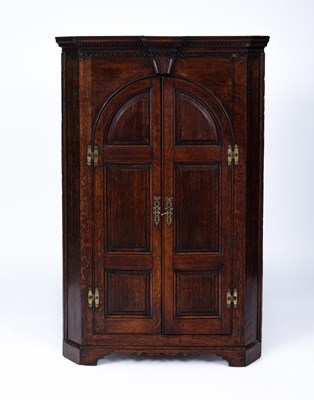 Lot 935 - A George III oak corner cupboard