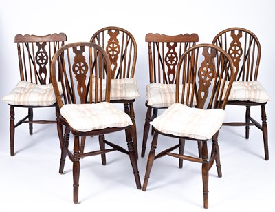 Lot 858 - A closely matched set of wheelback Windsor chairs
