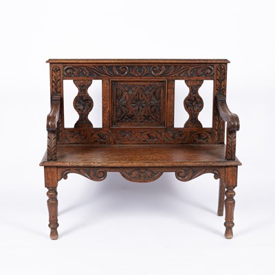 Lot 886 - An oak carved hall bench