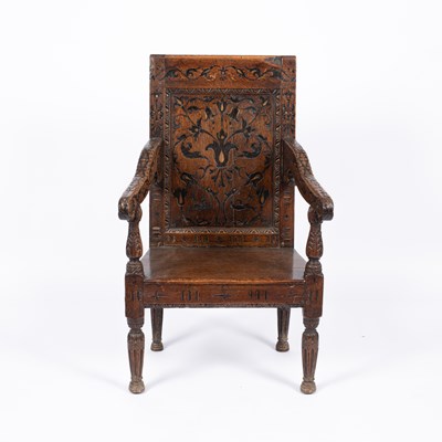Lot 819 - An oak panel back armchair